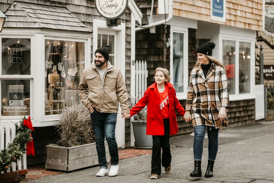 A family walking down Bearskin Neck in winter coats, Rockport