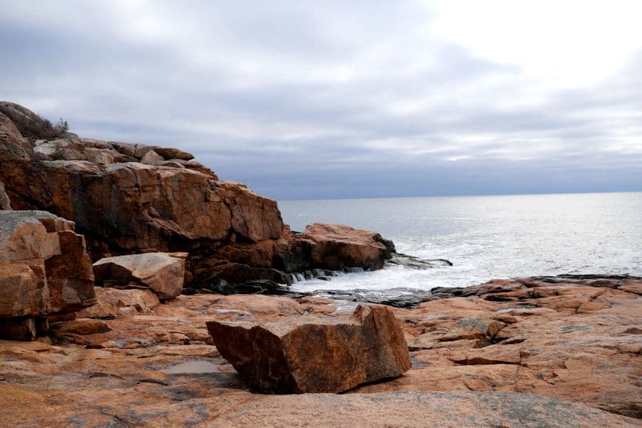 Granite ledges at Rafe's Chasm under an early-spring sky